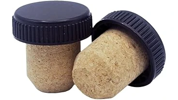 The image shows a close-up of a very expensive, ornate cork for a collectible bottle.