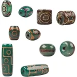 The image shows a collection of precious and ancient Dzi beads, highlighting rare examples from a top 10 list.