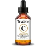 The image shows a luxurious collection of high-end face serums, highlighting top expensive skincare.