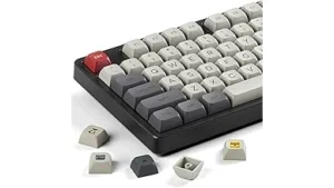 The image shows a keyboard with several ornate and uniquely crafted keycaps, hinting at the top 10 most expensive.