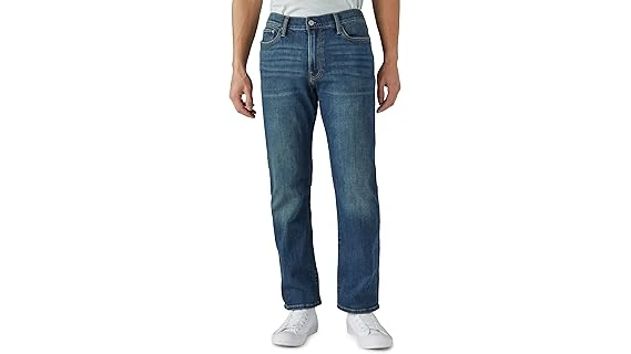 The image shows a close-up of luxurious, designer men's jeans, hinting at top expensive brands.