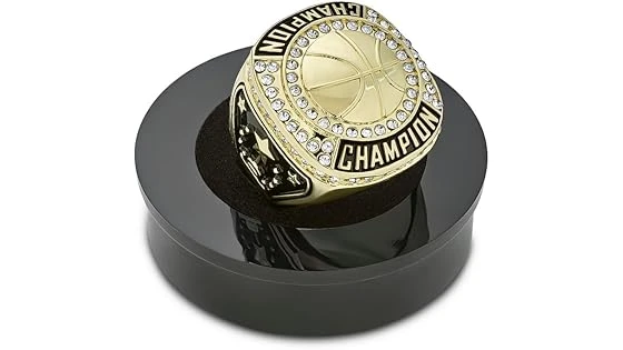 The image shows a glittering basketball championship ring, likely one of the most expensive NBA championship rings.