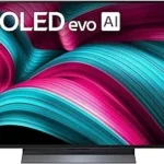 The image shows a luxurious living room displaying a premium OLED television, perfect for a top 10 expensive list.