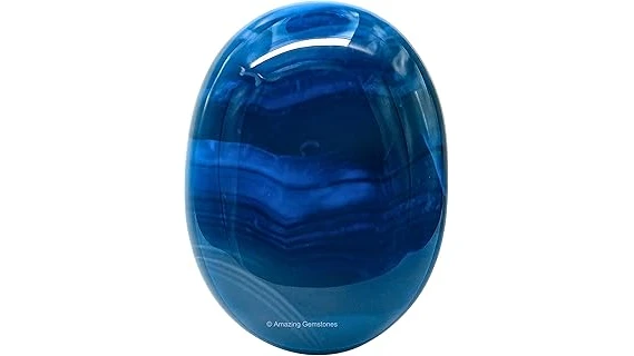 The image shows a polished black onyx gemstone, highlighting its deep color and natural beauty.