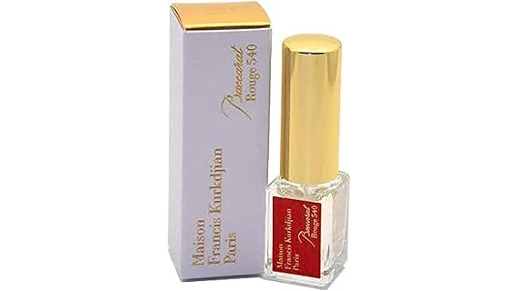 The image shows a luxurious Baccarat crystal perfume bottle with a golden stopper, showcasing its elegance.
