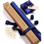 The image shows a beautifully wrapped gift box adorned with luxurious, patterned wrapping paper.