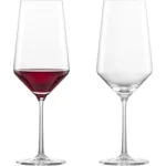 The image shows a collection of opulent wine bottles, representing the top four most expensive Bordeaux wines.
